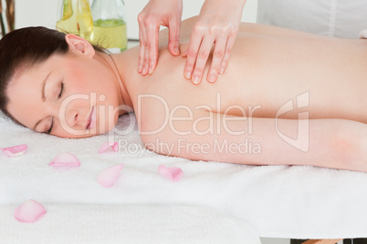 Young woman having a shoulder massage in a spa