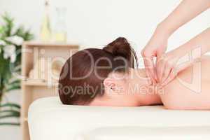 Red-haired woman receiving a back massage