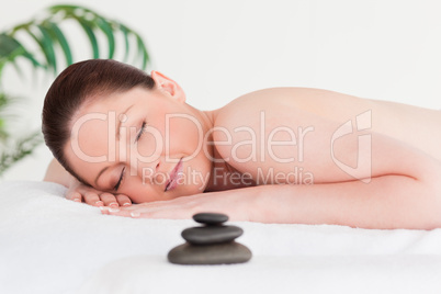 Red-haired woman lying on her belly in a spa