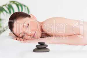 Red-haired woman lying on her belly in a spa