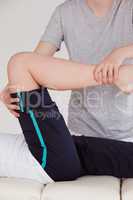 Portrait of a masseuse stretching the right leg of an athletic w