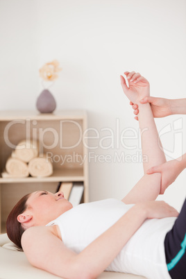 Portrait of a young woman having an arm massage