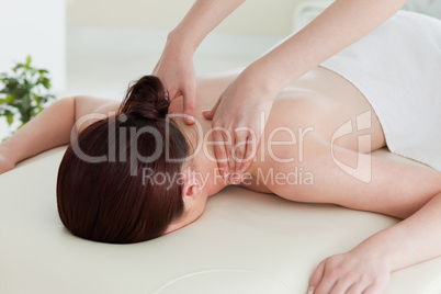 Close up of a young woman having a shoulder massage