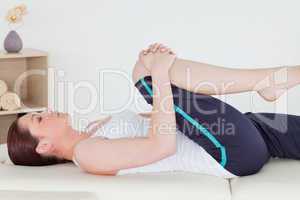 Sportswoman stretching her leg