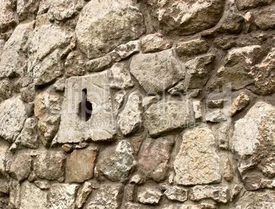 Ancient stone wall with loopholes