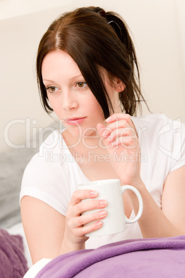Young student girl drink coffee in bed