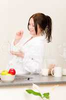 Young student girl eat cereal in kitchen