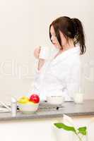 Young student girl have breakfast in kitchen