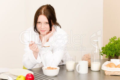 Young student girl eat cereal in kitchen