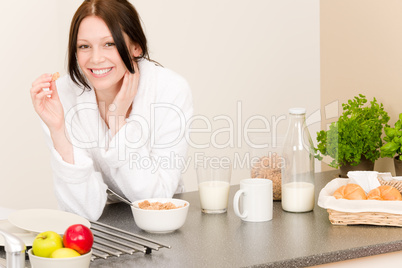 Young student girl eat cereal in kitchen