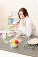 Young student girl have breakfast in kitchen