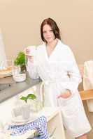 Young student girl have breakfast in kitchen