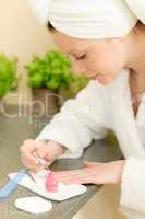 Young student girl polishing her nails
