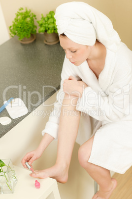 Young student girl polishing her toe nails
