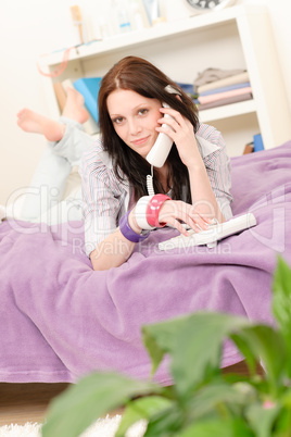 Young student girl speaking on phone lying