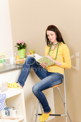 Young student girl reading book at home