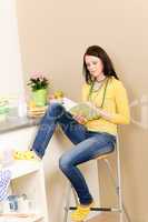 Young student girl reading book at home