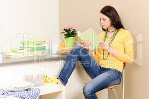 Young student girl reading book at home