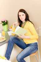 Young student girl reading book at home