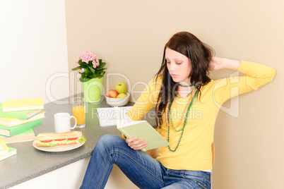 Young student girl reading book at home