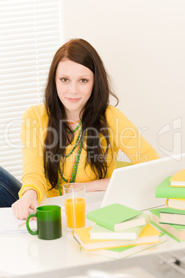Young student girl with laptop at home