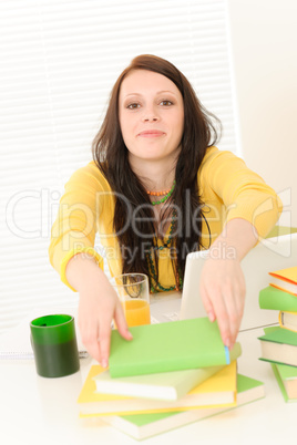 Young student girl with books at home