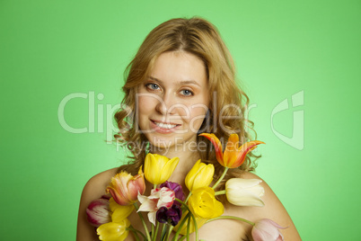 Happy Young Woman hugging a bouquet of tulips