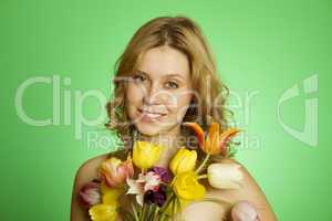 Happy Young Woman hugging a bouquet of tulips