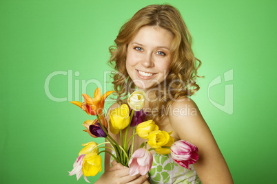 Happy Young Woman hugging a bouquet of tulips