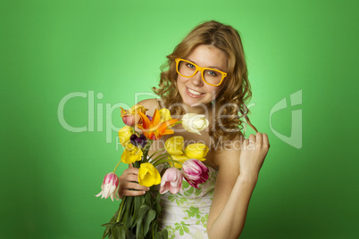 Happy Young Woman hugging a bouquet of tulips