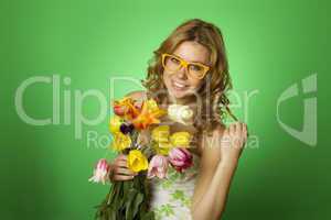 Happy Young Woman hugging a bouquet of tulips