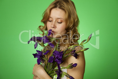 Attractive girl hugging a bouquet of Irises