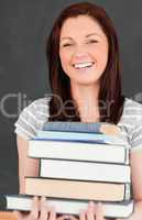 Laughing young woman bringing books