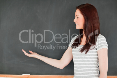 Redhead against a blackboard with a copy space