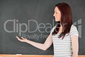 Redhead against a blackboard with a copy space