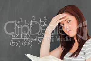 Thoughtful woman trying to solve an equation