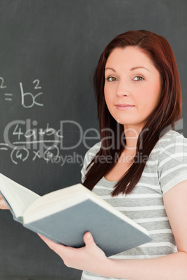 Portrait of a young woman trying to solve an equation