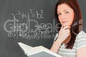 Reflective young woman trying to solve an equation