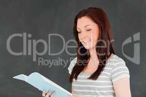 Happy young woman reading her notes