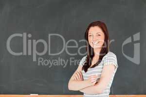 Beautiful woman standing in front of a blackboard