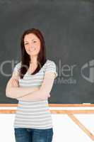 Young woman standing in front of a blackboard