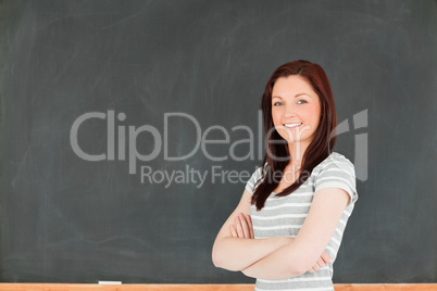 Cute woman standing in front of a blackboard