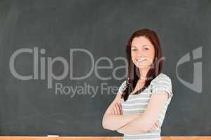 Cute woman standing in front of a blackboard