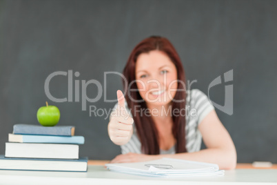 Cheerful cute student with the thumb up