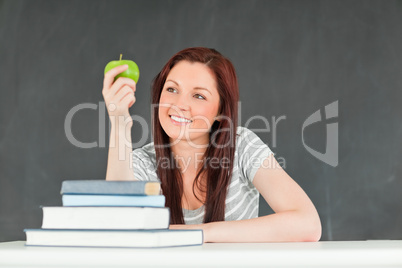 Young student holding an apple