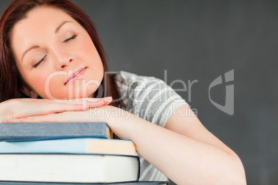 Young student asleep on her books