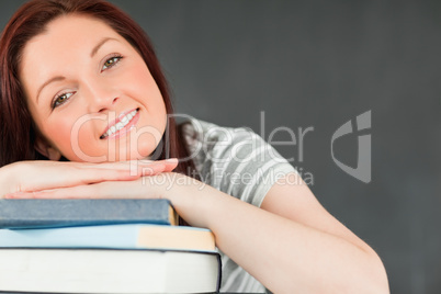 Smiling young student leaned on her books