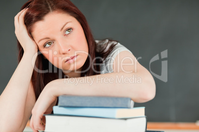 Close up of a beautiful bored student with her forearm on her bo