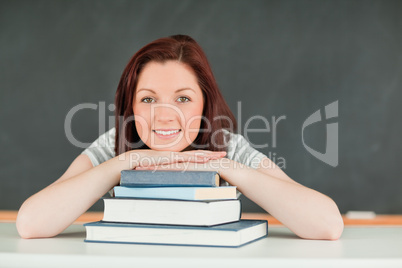 Young student with the chin on her books
