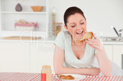 Attractive woman posing while eating a slice of bread
